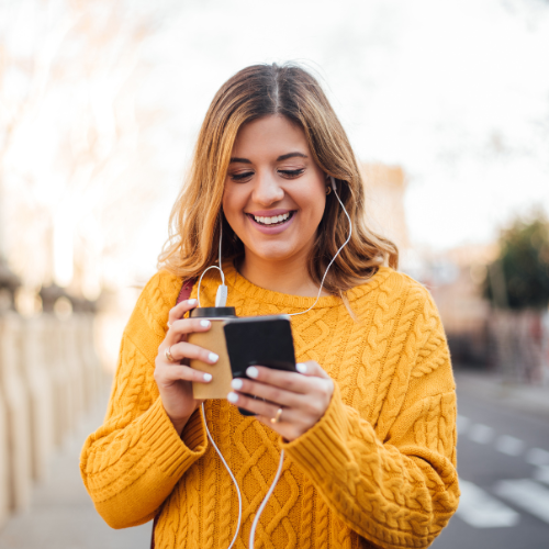 Woman reviewing her finances on a phone, considering subscription based financial planning, with Asper AI budget app as a tool.